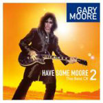 Gary Mooren "Have Some Moore vol 2" -kokoelman kansikuva. Kuvassa näkyy mustiin pukeutunut ja mustanväristä kitaraa soittava hevimies, jolla pörröinen musta tukka ja mustat aurinkolasit. Mies seisoo kellertävän auringon alla energistä taustaa vasten.