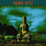 Uriah Heep -bändin "Wake The Sleeper" -albumin kansitaide. Albumissa näkyy bändin logo yläosassa sinistä taustaa vasten ja sen alla suuri muinainen patsashahmo sinertävää pilvitaivasta vasten. Kuva on synkkä ja hämärä.